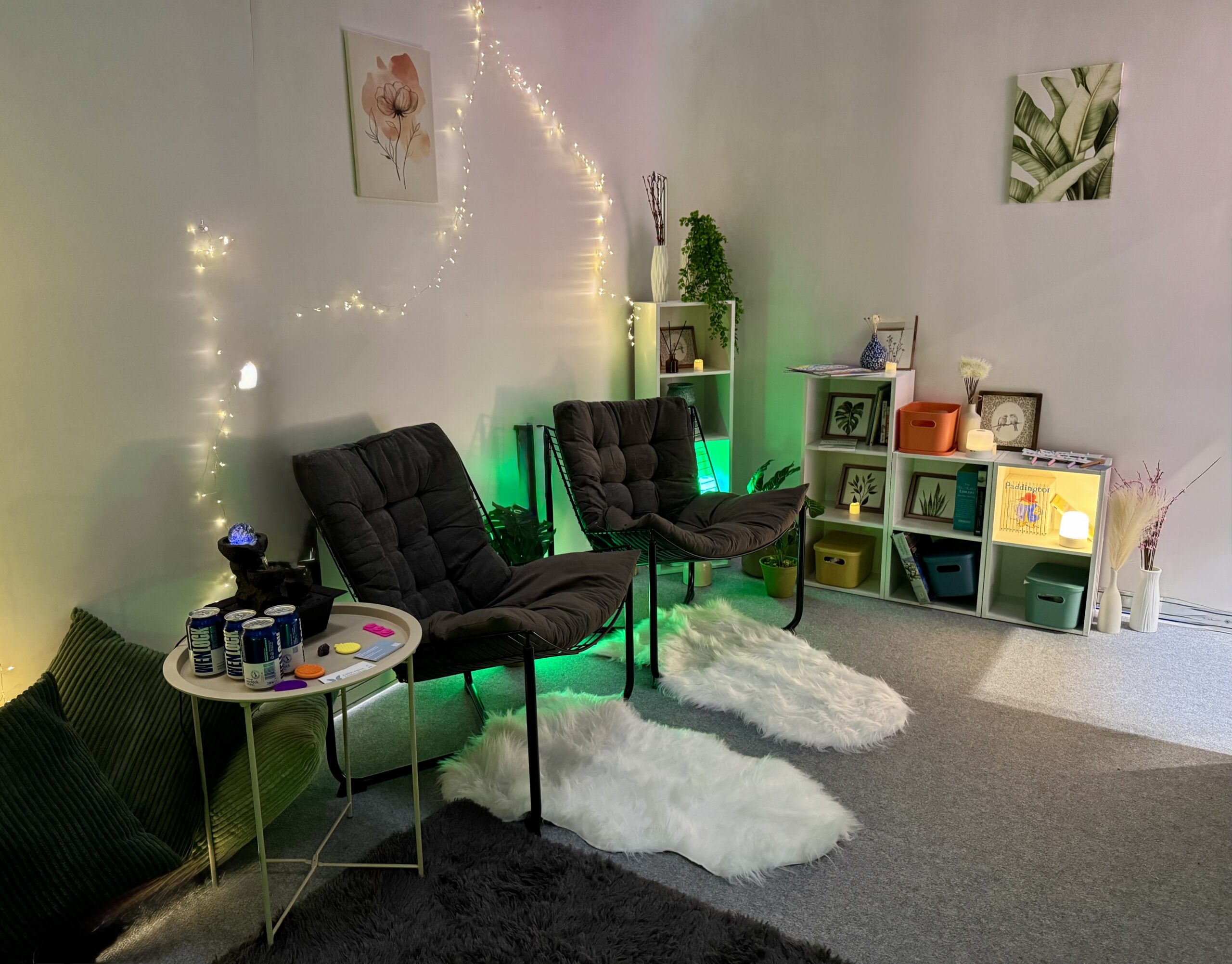 Calm Nest sensory room with patterned armchair, fairy lights, plants and green ambient lighting